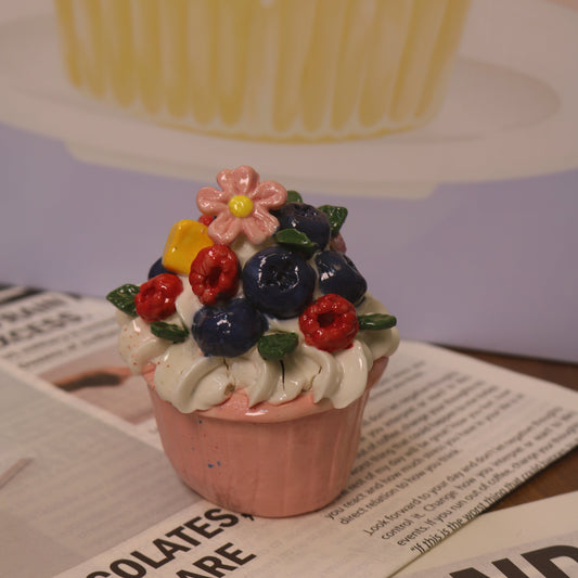 Small decorative flower pot with colorful flowers on a newspaper background